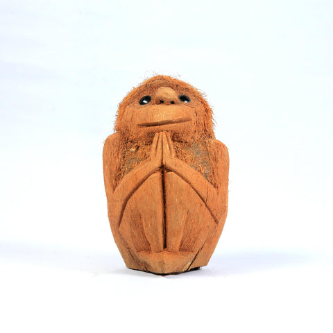 Coconut husk monkey carving with folded hands