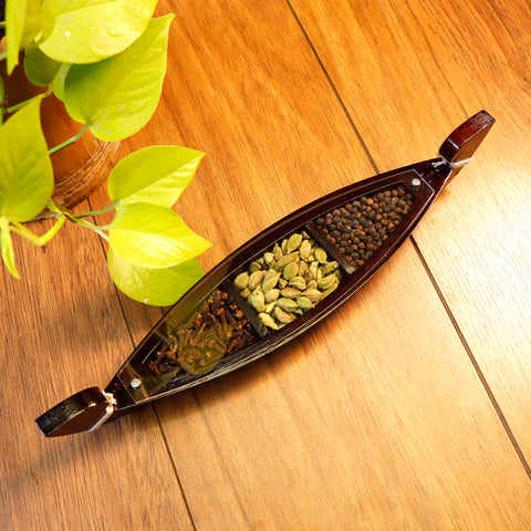 wooden kettuvallam with spices